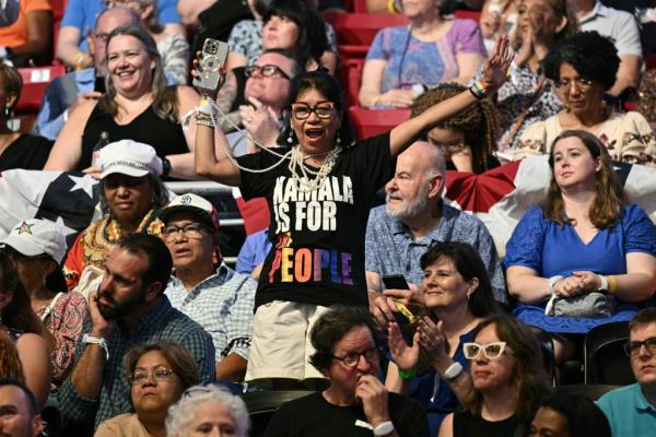 A supporter of US Vice President and 2024 Democratic presidential candidate Kamala Harris gestures during a campaign rally at Temple University's Liacouras Center in Philadelphia, Pennsylvania, August 6, 2024.
