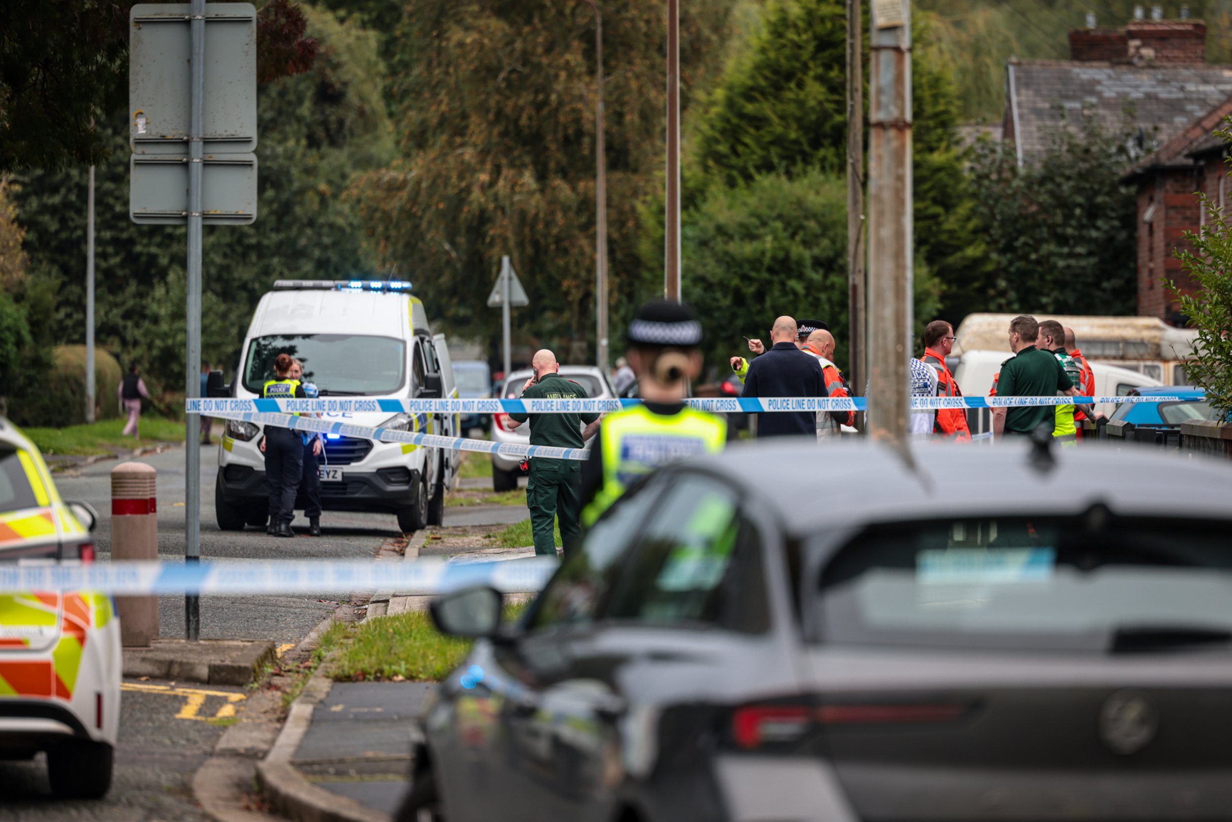 A cordon is in place on a street in Salford this afternoon (Sept 23) amid an ongoing police incident. Officers are at the scene on South Radford Street, Kersal, with a cordon in place near the junction with Kingsley Avenue. Caption: Police on South Bradford Street, Kersal, Salford, during an incident on 23 September 2024