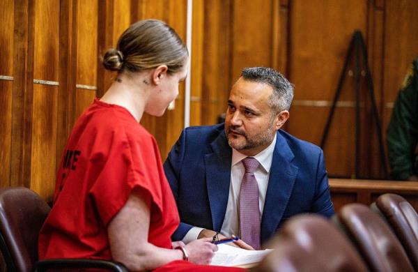 Social media model Courtney Clenney talks to her lawyer Frank Prieto during a detention hearing on Nov. 15, 2022, in Miami.