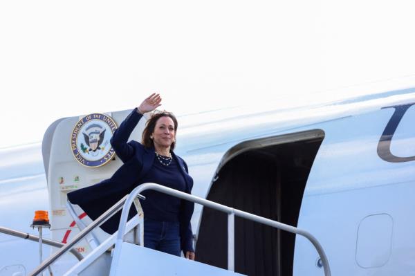 US Vice President and Democratic presidential nominee Kamala Harris waves as she boards Air Force Two before departing from LaGuardia Airport in New York on October 9, 2024. Harris travels to Las Vegas, Nevada, for campaign events. (Photo by Charly TRIBALLEAU / AFP)