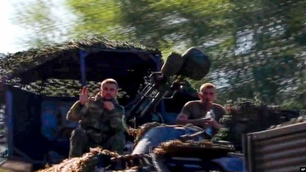 In this image taken from video released by the Russian Defense Ministry on Aug. 9, 2024, soldiers sit in a military truck as a column of the Russian Armed Forces move to build up forces fighting Ukrainian formations in the Sudzhansky district of Kursk region of Russia.