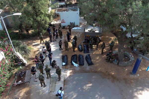 An aerial view shows the bodies of victims of an attack following a mass infiltration by Hamas gunmen from the Gaza Strip, lie on the ground in Kibbutz Kfar Aza