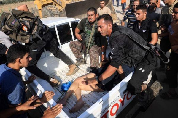 Graphic content / Palestinian militants surround a truck reportedly carrying a captured Israeli woman, in Khan Yunis in the souther Gaza Strip, on Oct. 7, 2023.