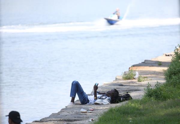 Migrant lounges on Randall's Island.