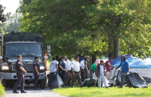 Dozens of tents and (about) a hundred migrants are camped along the bike path on the west side of Randall's Island near the Ward's Island pedestrian bridge and the City-run mirgant shelter.