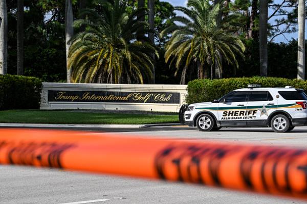 A sheriff's car blocks the street outside the Trump International Golf Club