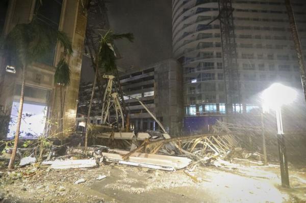 Debris covers the ground near a crane that fell onto a building along 1st Avenue South in St. Petersburg as Hurricane Milton's strong winds tore through the area Thursday, October 10, 2024. Picture: Chris Urso/Tampa Bay Times via AP