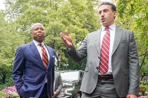NYC Mayor Eric Adams in suit leaving Gracie Mansion, conversing briefly with his lawyer Alex Spiro, also in suit, during a press interaction