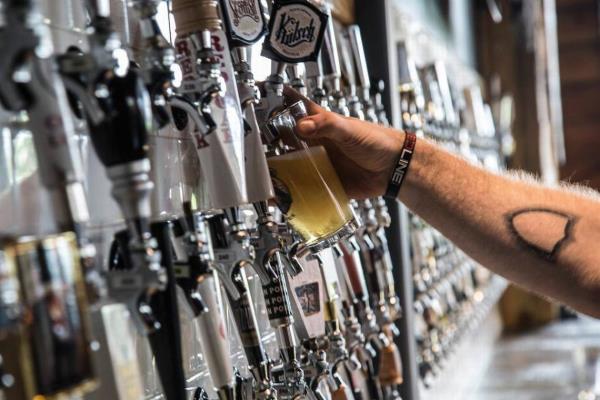 Jacob Trager fills a pint glass Thursday, July 30, 2015 at the newly opened Raleigh Beer Garden on Glenwood Avenue. The beer garden boasts 366 beers on tap with the bottom floor serving 144 North Carolina brewed beers.