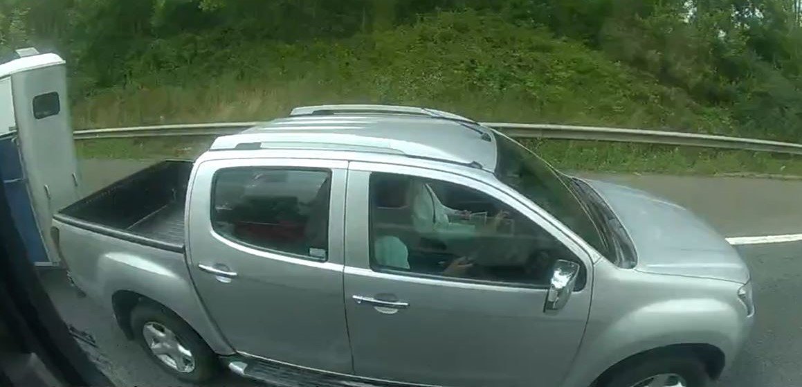 The driver of this Isuzu 4x4 was towing a horse box trailer on the M40, whilst using a handheld mobile phone. Police using an unmarked HGV caught a driver using his mobile phone while steering with his KNEES. A lorry driver was also spotted with their feet up while on their phone. The reckless motorists were among 129 drivers caught driving illegally over a four-day period. Warwickshire Police were patrolling the M40, M42 and A46 in an undercover lorry between July 22-26 this year.