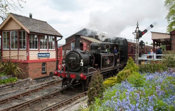 Tank steam locomotive 32670 departing the quaint Tenterden Town station