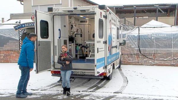 Chabo and his owner Caroline Zordel leaving Landines’ mobile veterinary office.