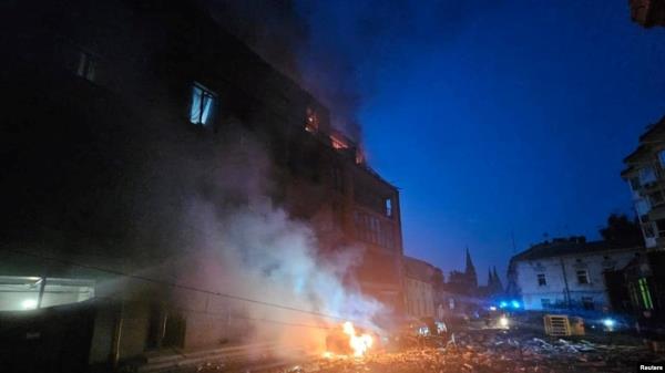 A residential building and a car burn following Russian missile and drone strikes in Lviv, Ukraine, Sept. 4, 2024. 