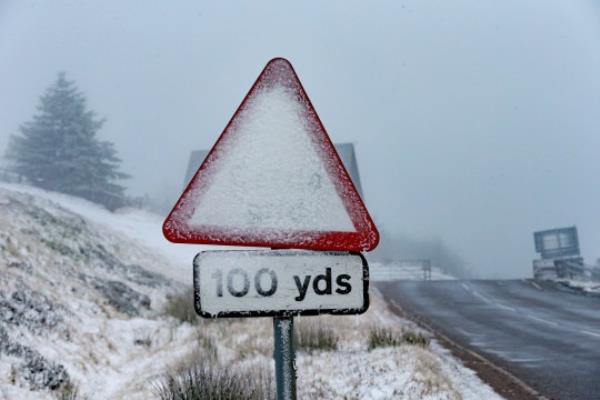 Snowy sign in Scotland, which saw snowfall over the weekend as cold weather warning issued.