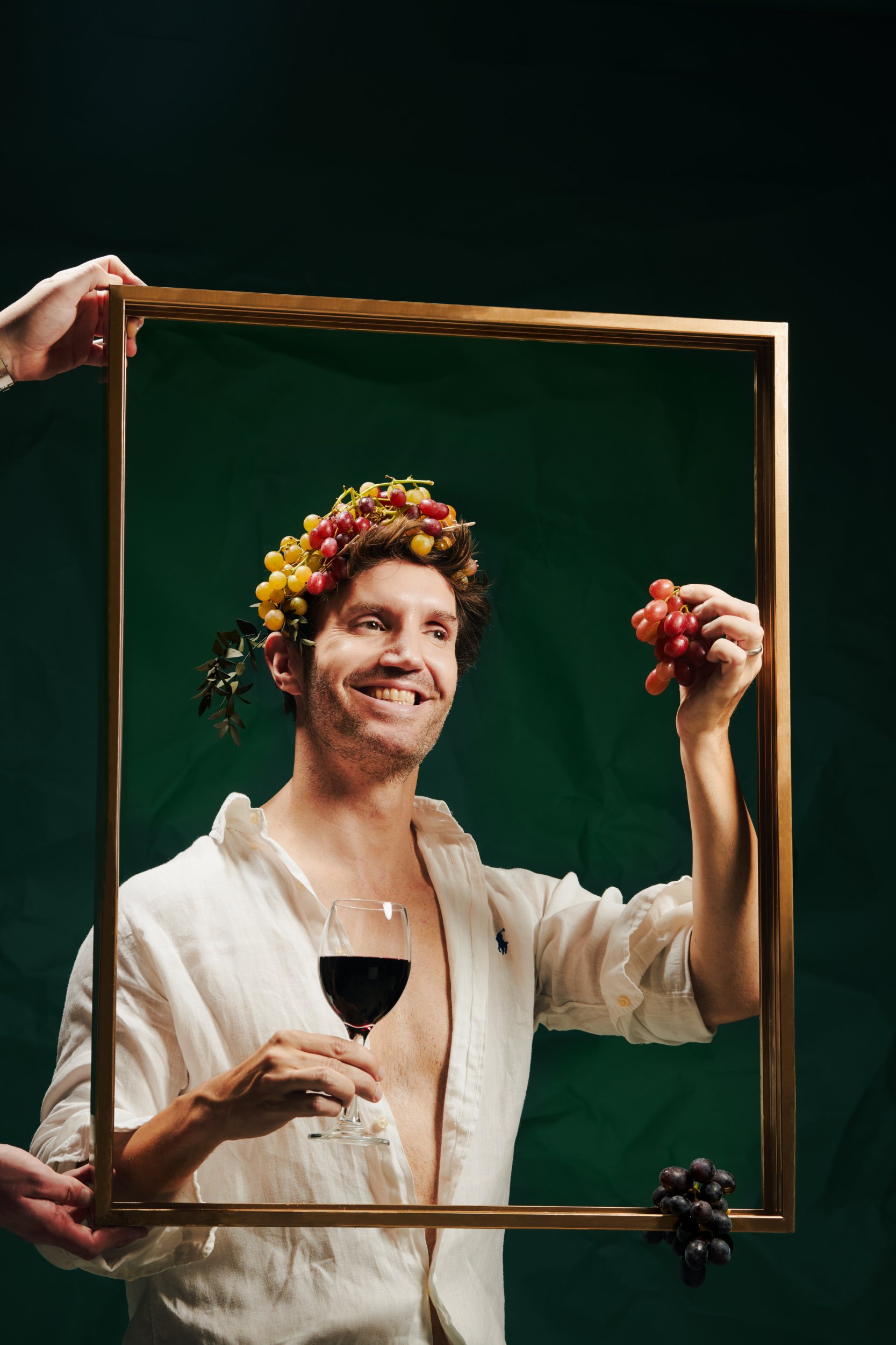 Metro, drinks writer Rob Buckhaven holding grapes and a glass of red wine.