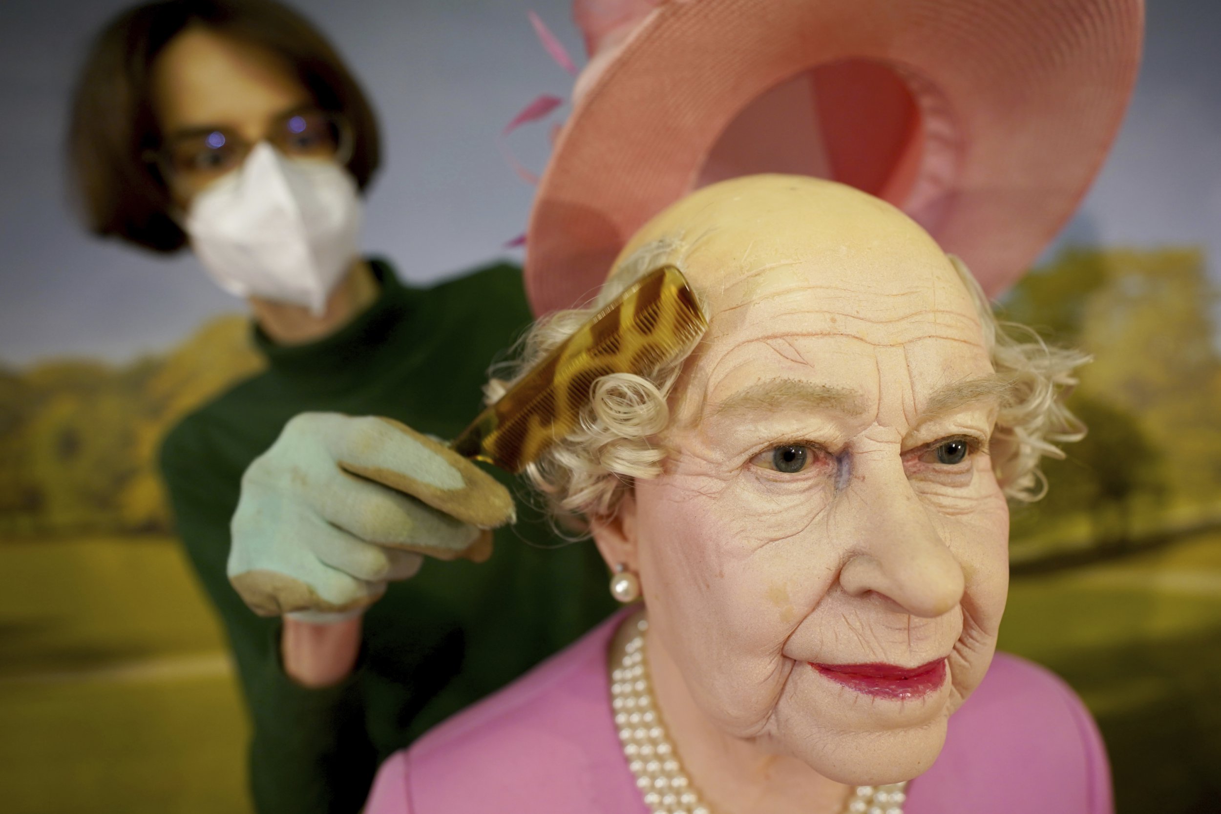The wax figure of Queen Elizabeth II is combed by Panoptikum boss Susanne Faerber at the Panoptikum on the Reeperbahn in Hamburg, Germany