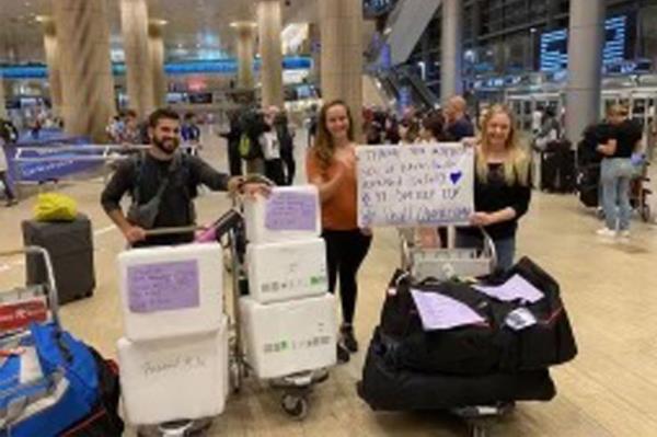 Ayelet Oreg, who studies the motivations of bereaved mothers for donating their human milk to nonprofit milk banks in Israel, accepts the breast milk donations at Tel Aviv Airport on Friday.