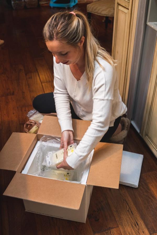 woman putting her frozen breast milk into a cooler to be shipped to Milkify