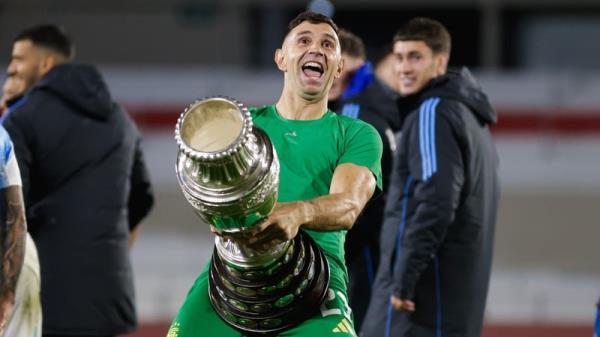 Emiliano Martinez celebrates with a replica Copa America trophy after Argentina's World Cup qualifier win over Chile earlier this month
