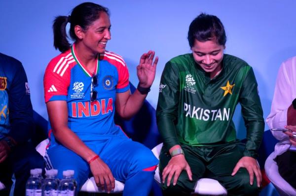 India captain Harmanpreet Kaur, left, shares a laugh with Pakistan captain Fatima Sana during a special panel session featuring captains of the 10 countries participating in the Women's T20 World Cup at Dubai International Stadium in Dubai, United Arab Emirates, Wednesday, October 2, 2024. (AP Photo/Altaf Qadri)