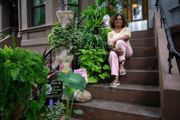 Althea Joseph sitting on stoop with plants