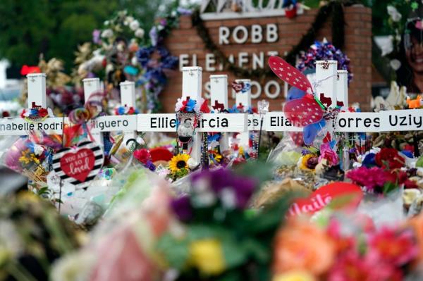 Flowers and other items surround crosses at a memorial, June 9, 2022, for the victims of a shooting at Robb Elementary School in Uvalde, Texas