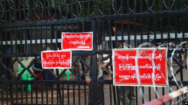 FILE - Prison officers and police gather near a prison entrance in Yangon, Myanmar, Oct. 18, 2021. Reports show several people sentenced to death in closed-doors trials in 2023 could soon be executed, a United Nations official said Monday. 
