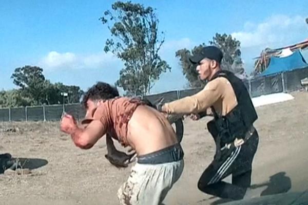 A Hamas terrorists captures a man during the Supernova music festival near Kibbutz Reim on Saturday.