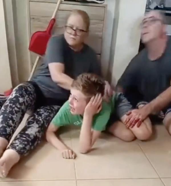 A family was caught on video reportedly being held hostage by terrorists during the initial attack on Saturday.