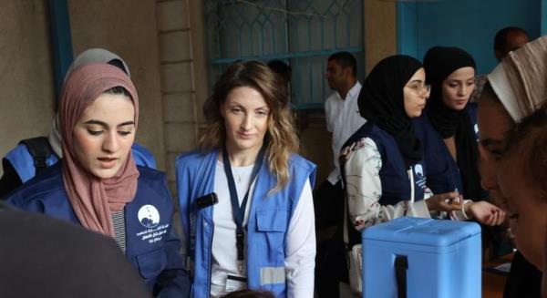 Louise Wateridge, UNRWA Spokesperson (middle) following the administering of polio vaccination in UNRWA's Deir El Balah health center. Louise Wateridge, UNRWA Spokesperson (middle) following the administering of polio vaccination in UNRWA's Deir El Balah health center.