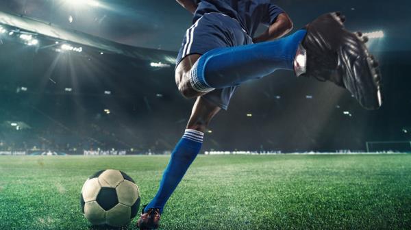 soccer player kicking ball