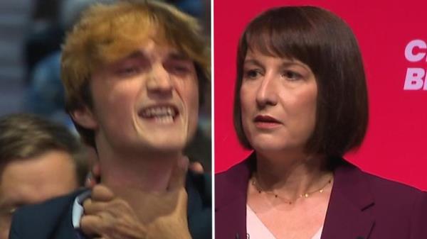 Heckler is ejected during chancellor's conference speech