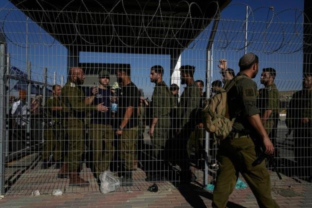 Soldiers in green fatigues gather 