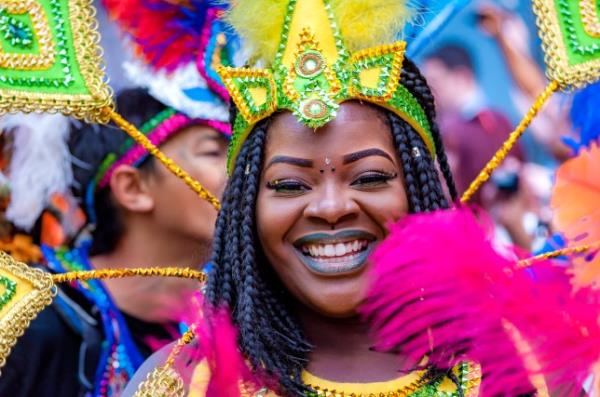 Street dancer wearing a colourful headpiece at London's Notting Hill Carnival