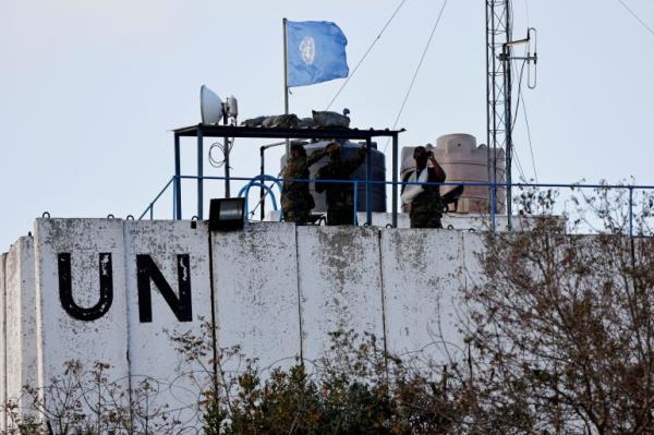 Members of the United Nations peacekeepers (UNIFIL) look at the Lebanese-Israeli border from a watchtower
