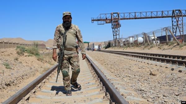 A Taliban security official walks at the construction site of railway tracks during the inauguration ceremony of the TAPI pipeline project, at the Turghundi border post in Kushk district of Herat province in Afghanistan on Sept. 11, 2024.