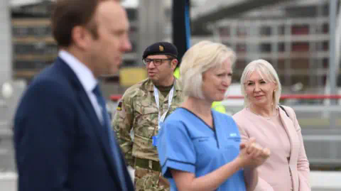 Getty Images Photograph of Ruth May alongside Matt Hancock and Nadine Dorries in April 2020.