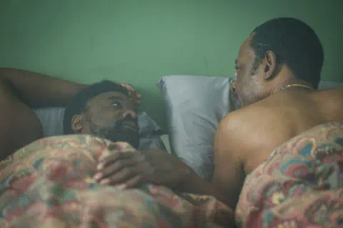 BBC/Fable Pictures/Des Willie Morris De La Roux, played by Ariyon Bakare and Barry Walker, played by Lennie James, lying in bed looking at one another