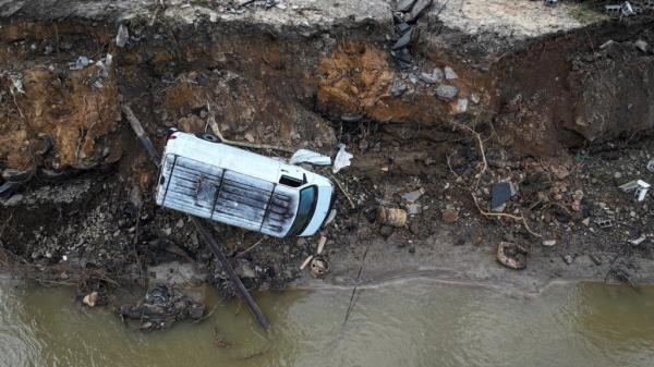 A drone view of a van toppled over on a crumbled embankment along the Swannanoa River after Storm Helene passed through the area, in Swannanoa, North Carolina, U.S. October 3, 2024.