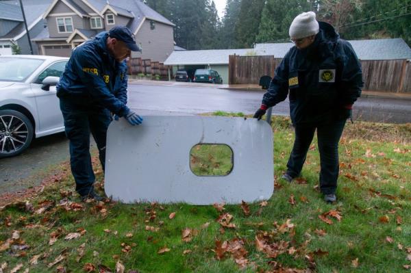 Investigators recover the door plug that fell off Alaska Airlines Flight 1282 in Portland, Ore. on Jan. 8, 2024.