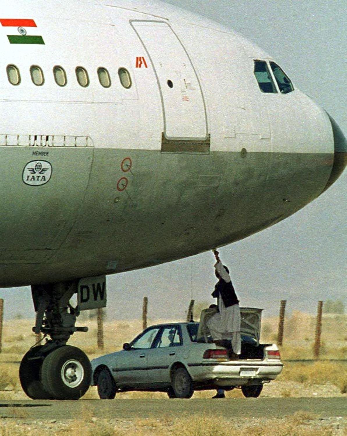 A Taliban security official receives a paper on which the hijackers of Indian Airlines flight IC-814 have put their demands at Khandahar airport, 27 December, 1999.