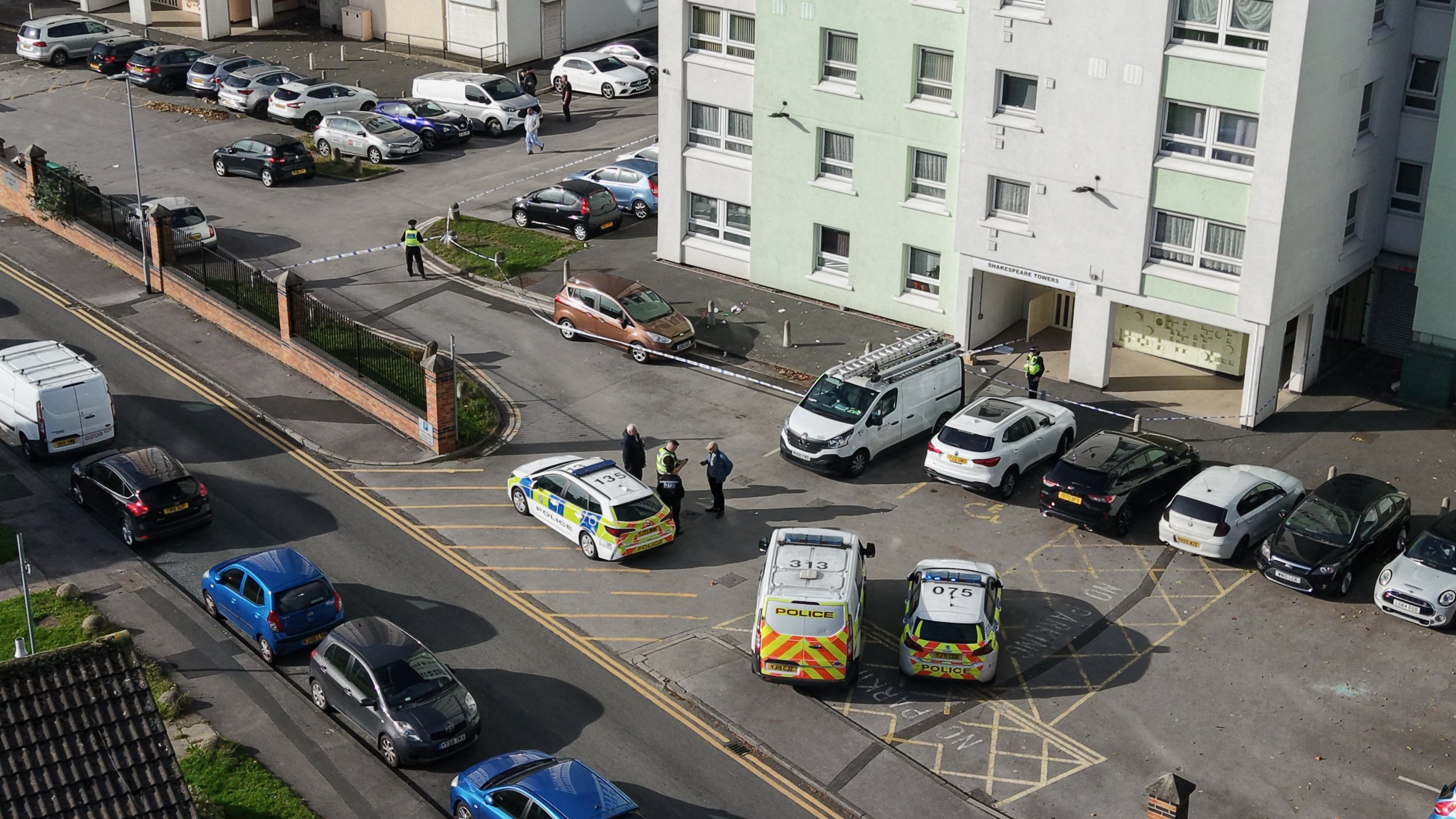 Police scene outside block of flats.