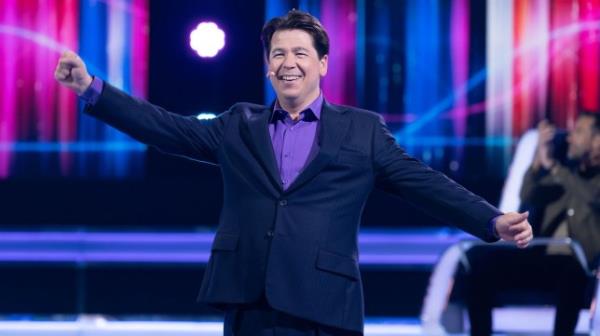 Michael McIntyre with his arms outstretched on The Wheel