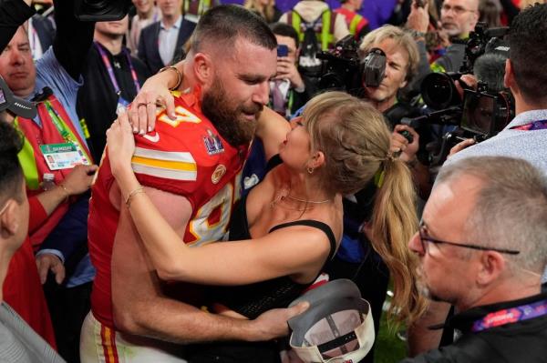 Travis Kelce and Taylor Swift walk together after an AFC Championship NFL football game between the Chiefs and the Baltimore Ravens, Jan. 28, 2024, in Baltimore.