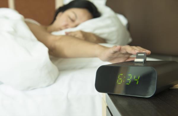 woman turning off her alarm, dad jokes