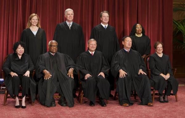 Group photo of Supreme Court Justices including Sonia Sotomayor, Clarence Thomas, John G. Roberts, Samuel A. Alito, Elena Kagan, Amy Coney Barrett, Neil M. Gorsuch, Brett M. Kavanaugh and Ketanji Brown Jackson, all in black robes, taken on Oct 7, 2022.