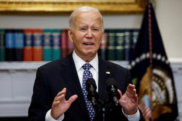 U.S. President Joe Biden delivering remarks on the response to Hurricane Helene, speaking into microphones in the Roosevelt Room of the White House, September 30, 2024.