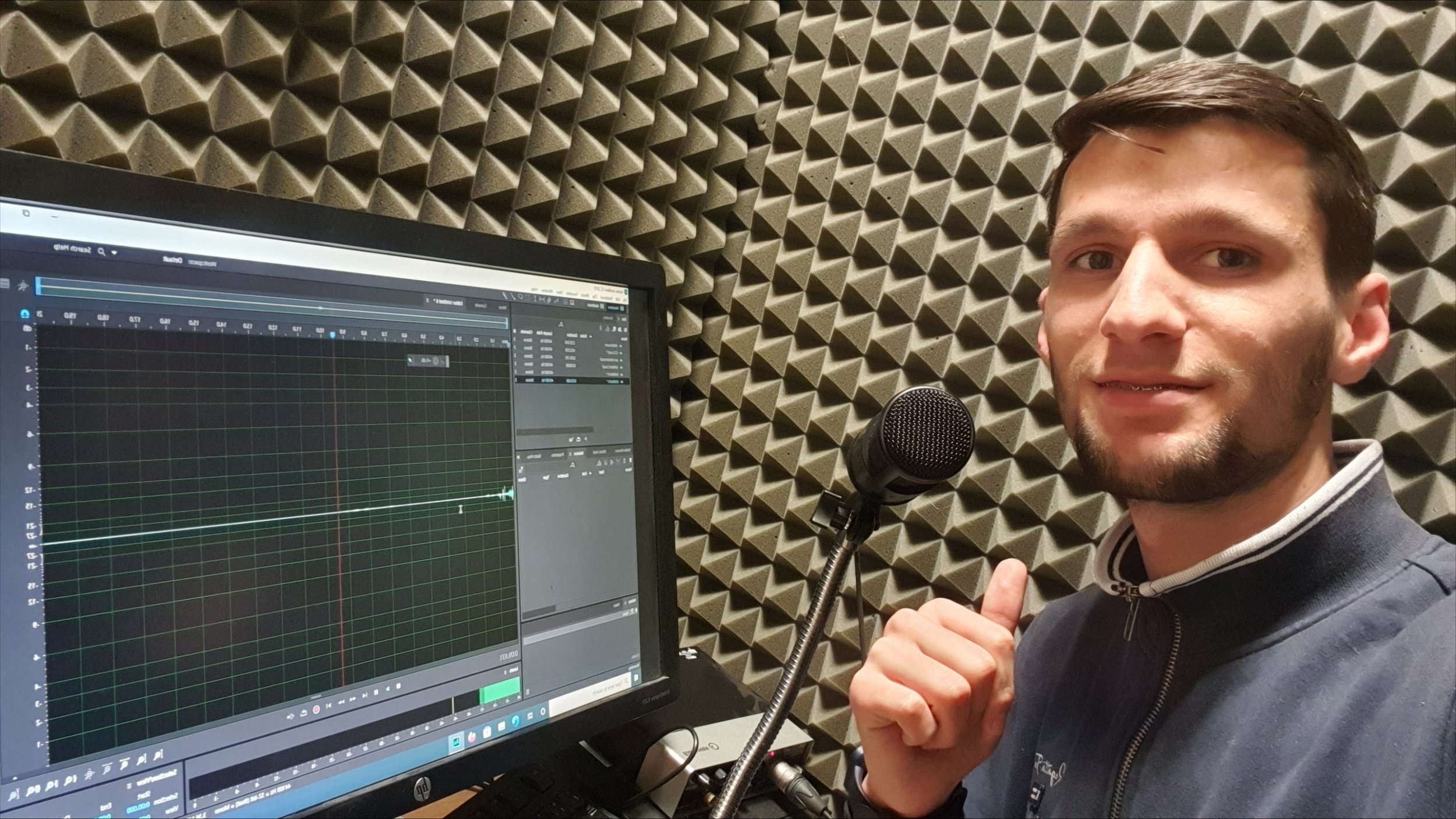 Gezim takes a selfie at a podcast studio