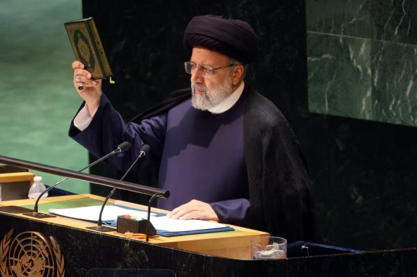 Iran's President Ebrahim Raisi holds the Koran as he address world leaders during the United Nations (UN) General Assembly.