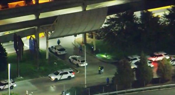 The two officers, a 50-year-old and a 60-year-old, had just stepped out of their vehicle inside the garage when they "observed a few individuals breaking into another vehicle."